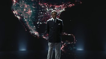 Movie still from “RoboCop” (2014), directed by José Padilha – A man standing in front of a map of the united states of america; Medium shot, Low angle