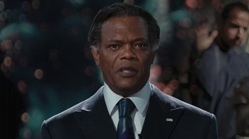 Movie still from “RoboCop” (2014), directed by José Padilha – A person wearing a suit and a tie; Close Up shot, Low angle