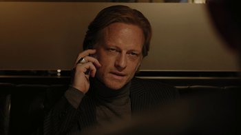 Movie still from “RoboCop” (2014), directed by José Padilha – A person talking on a cell phone; Close Up shot, Low angle