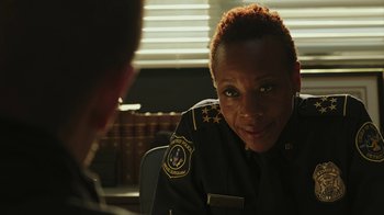 Movie still from “RoboCop” (2014), directed by José Padilha – A woman in a police uniform talking to a man; Close Up shot, Over the shoulder angle