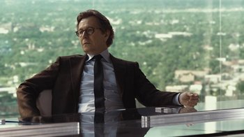 Movie still from “RoboCop” (2014), directed by José Padilha – A man sitting at a table in front of a window; Medium shot, Low angle