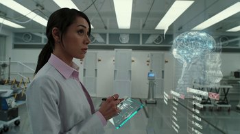 Movie still from “RoboCop” (2014), directed by José Padilha – A woman in a white lab coat holding a tablet; Close Up shot, Over the shoulder angle