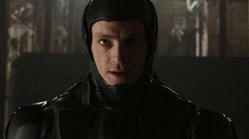 Movie still from “RoboCop” (2014), directed by José Padilha – A man in a black suit and a helmet; Close Up shot, High angle
