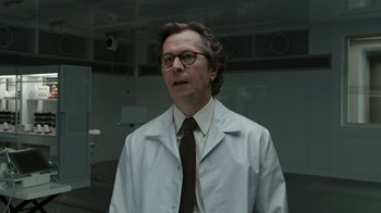 Movie still from “RoboCop” (2014), directed by José Padilha – A man wearing a lab coat and tie; Close Up shot, Low angle