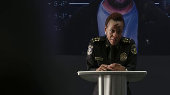 Movie still from “RoboCop” (2014), directed by José Padilha – A police officer sitting in front of a microphone; Close Up shot, Low angle