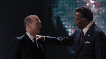 Movie still from “RoboCop” (2014), directed by José Padilha – Two men in suits and ties fixing one of them's ties; Medium shot, Low angle