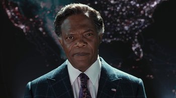 Movie still from “RoboCop” (2014), directed by José Padilha – A person wearing a suit and tie; Close Up shot, Low angle