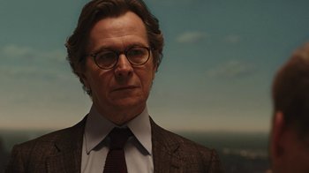 Movie still from “RoboCop” (2014), directed by José Padilha – A person wearing a suit and tie; Close Up shot, Low angle