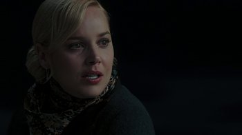 Movie still from “RoboCop” (2014), directed by José Padilha – A woman wearing a black jacket and a leopard print scarf; Close Up shot, Over the shoulder angle