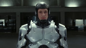 Movie still from “RoboCop” (2014), directed by José Padilha – A man wearing a helmet and a suit of armor; Close Up shot, Low angle