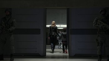 Movie still from “RoboCop” (2014), directed by José Padilha – A woman and a child are walking through a building; Wide shot, Low angle