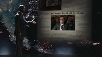 Movie still from “RoboCop” (2014), directed by José Padilha – A man standing in front of a news story; Medium shot, Over the shoulder angle