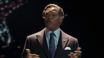 Movie still from “RoboCop” (2014), directed by José Padilha – A man in a business suit and tie; Close Up shot, Low angle