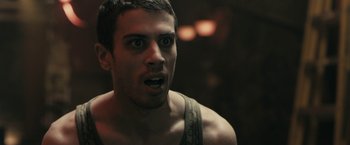 Movie still from “RocknRolla” (2008), directed by Guy Ritchie – A person with his mouth wide open; Close Up shot, Over the shoulder angle