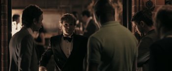 Movie still from “RocknRolla” (2008), directed by Guy Ritchie – A man in a tuxedo talking to another man in a suit; Medium shot, Over the shoulder angle