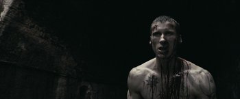 Movie still from “RocknRolla” (2008), directed by Guy Ritchie – A man with blood all over his face and chest; Close Up shot, Low angle