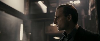 Movie still from “RocknRolla” (2008), directed by Guy Ritchie – A person wearing a black shirt; Close Up shot, Low angle