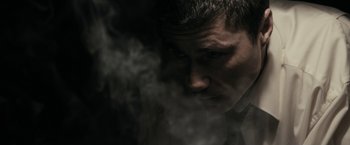 Movie still from “RocknRolla” (2008), directed by Guy Ritchie – A person smoking a cigarette; Close Up shot, Low angle