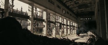 Movie still from “RocknRolla” (2008), directed by Guy Ritchie – A building that has many windows on the side of it; Extreme Wide shot, High angle