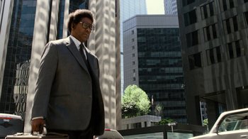 Movie still from “Roman J. Israel, Esq.” (2017), directed by Dan Gilroy – A man in a suit and tie standing in front of a building; Medium shot, Low angle