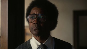 Movie still from “Roman J. Israel, Esq.” (2017), directed by Dan Gilroy – A person wearing glasses and a tie; Close Up shot, Low angle