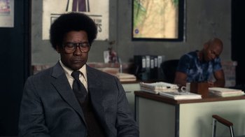 Movie still from “Roman J. Israel, Esq.” (2017), directed by Dan Gilroy – A man in a suit sitting in front of a computer monitor; Medium shot, Over the shoulder angle
