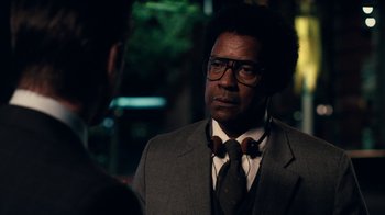 Movie still from “Roman J. Israel, Esq.” (2017), directed by Dan Gilroy – A man in a suit and tie talking to another man; Close Up shot, Over the shoulder angle