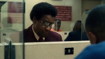 Movie still from “Roman J. Israel, Esq.” (2017), directed by Dan Gilroy – A man in a suit looking at a computer screen in an office cubicle; Close Up shot, Over the shoulder angle