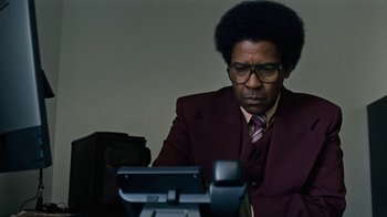Movie still from “Roman J. Israel, Esq.” (2017), directed by Dan Gilroy – A man in a suit and tie looking at a camera; Close Up shot, Low angle