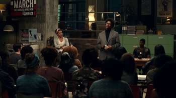 Movie still from “Roman J. Israel, Esq.” (2017), directed by Dan Gilroy – A man and a woman in front of an audience; Wide shot, Over the shoulder angle