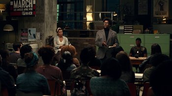 Movie still from “Roman J. Israel, Esq.” (2017), directed by Dan Gilroy – A man and a woman in front of an audience; Wide shot, Over the shoulder angle
