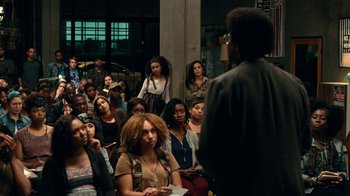 Movie still from “Roman J. Israel, Esq.” (2017), directed by Dan Gilroy – A group of people sitting in front of a man; Wide shot, High angle