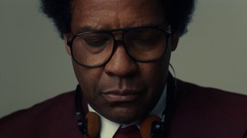 Movie still from “Roman J. Israel, Esq.” (2017), directed by Dan Gilroy – A person wearing glasses and headphones; Close Up shot, Low angle