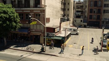 Movie still from “Roman J. Israel, Esq.” (2017), directed by Dan Gilroy – People are walking on the sidewalk near a bus stop; Extreme Wide shot, High angle