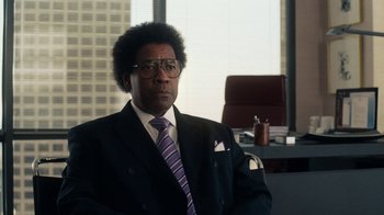 Movie still from “Roman J. Israel, Esq.” (2017), directed by Dan Gilroy – A man sitting in a chair in front of a window; Close Up shot, Over the shoulder angle