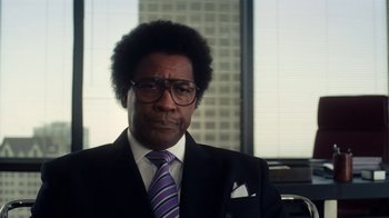 Movie still from “Roman J. Israel, Esq.” (2017), directed by Dan Gilroy – A man in a suit and tie in front of a window; Close Up shot, Over the shoulder angle