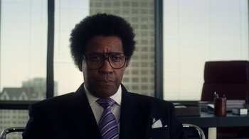 Movie still from “Roman J. Israel, Esq.” (2017), directed by Dan Gilroy – A man in a suit and tie in front of a window; Close Up shot, Low angle