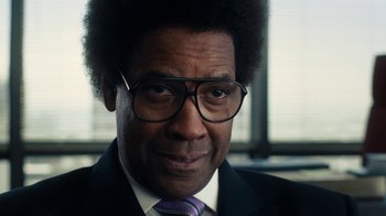 Movie still from “Roman J. Israel, Esq.” (2017), directed by Dan Gilroy – A person wearing glasses and a suit; Close Up shot, Over the shoulder angle