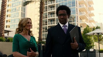 Movie still from “Roman J. Israel, Esq.” (2017), directed by Dan Gilroy – A man and a woman standing next to each other in front of a building; Medium shot, Low angle