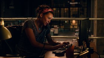 Movie still from “Roman J. Israel, Esq.” (2017), directed by Dan Gilroy – A woman sitting in front of a computer at a desk; Medium shot, High angle