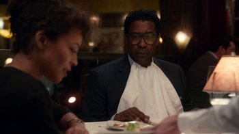 Movie still from “Roman J. Israel, Esq.” (2017), directed by Dan Gilroy – A man and a woman sitting at a dinner table; Medium shot, Over the shoulder angle