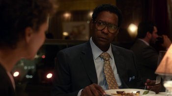 Movie still from “Roman J. Israel, Esq.” (2017), directed by Dan Gilroy – A man in a suit and tie sitting at a dinner table; Close Up shot, Over the shoulder angle