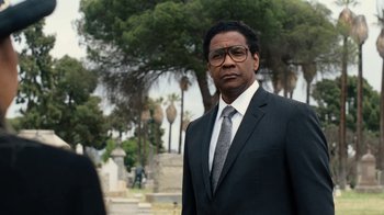 Movie still from “Roman J. Israel, Esq.” (2017), directed by Dan Gilroy – A man in a suit and tie standing in front of a cemetery; Close Up shot, Over the shoulder angle