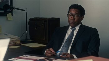 Movie still from “Roman J. Israel, Esq.” (2017), directed by Dan Gilroy – A man sitting at a desk in front of a laptop computer; Medium shot, Over the shoulder angle