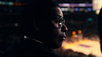Movie still from “Roman J. Israel, Esq.” (2017), directed by Dan Gilroy – A person wearing a suit and wearing glasses; Close Up shot, Low angle