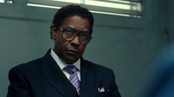 Movie still from “Roman J. Israel, Esq.” (2017), directed by Dan Gilroy – A man in a suit and tie wearing glasses; Close Up shot, Low angle