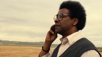 Movie still from “Roman J. Israel, Esq.” (2017), directed by Dan Gilroy – A man with glasses talking on a cell phone; Close Up shot, Low angle