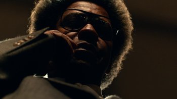 Movie still from “Roman J. Israel, Esq.” (2017), directed by Dan Gilroy – A person wearing glasses and a hat; Close Up shot, Low angle