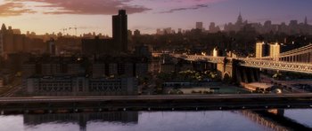 An aerial view of a city with a bridge in the background