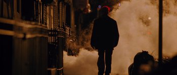 A man walking down the street in the fog